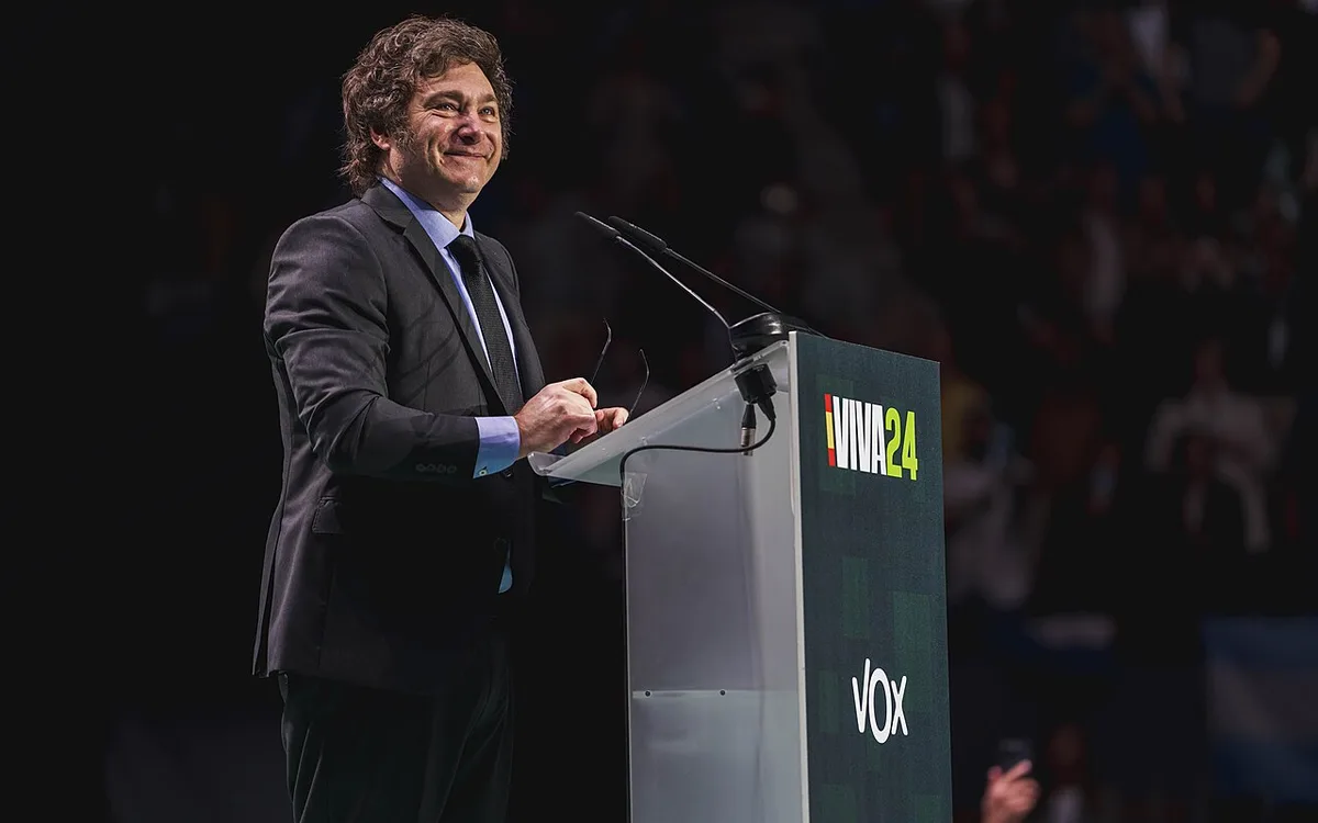 Argentine President Javier Milei speaking at a lectern during a political event