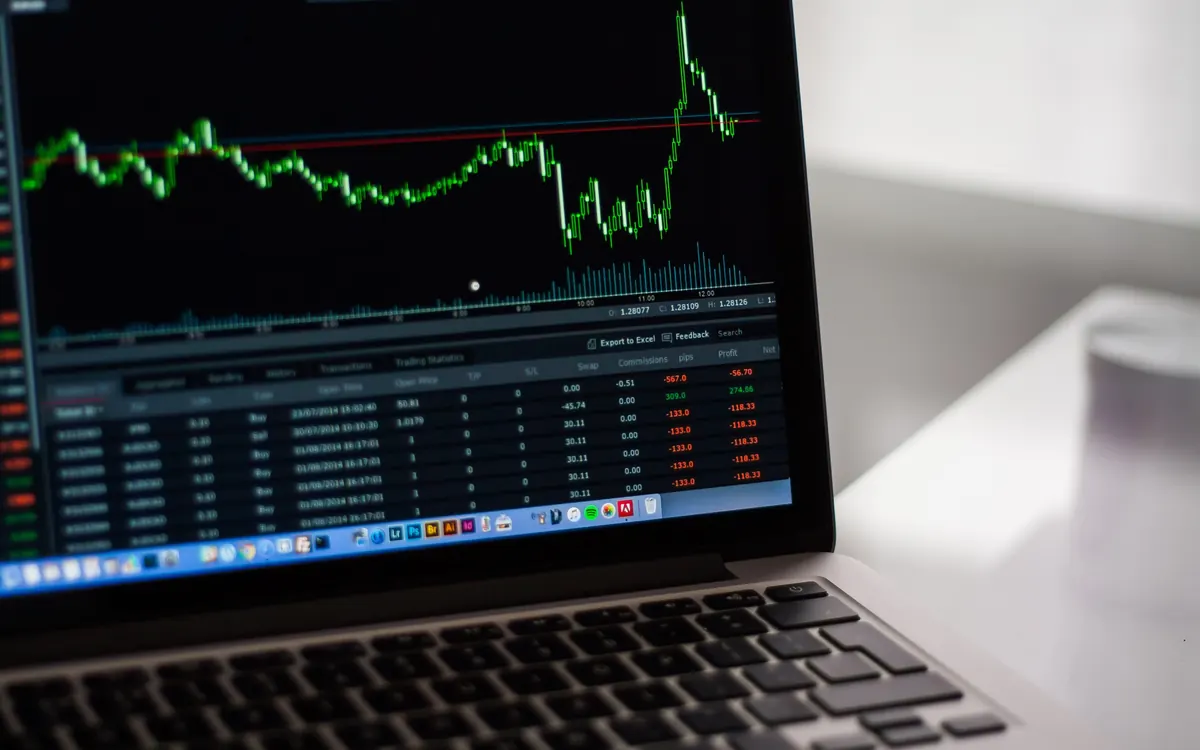 Laptop screen showing a price chart and an order table (illustrative photo)