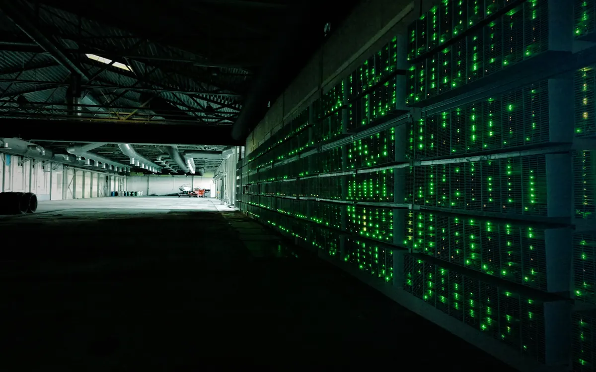 Rows of cryptocurrency mining machines in a mining farm (illustrative photo)