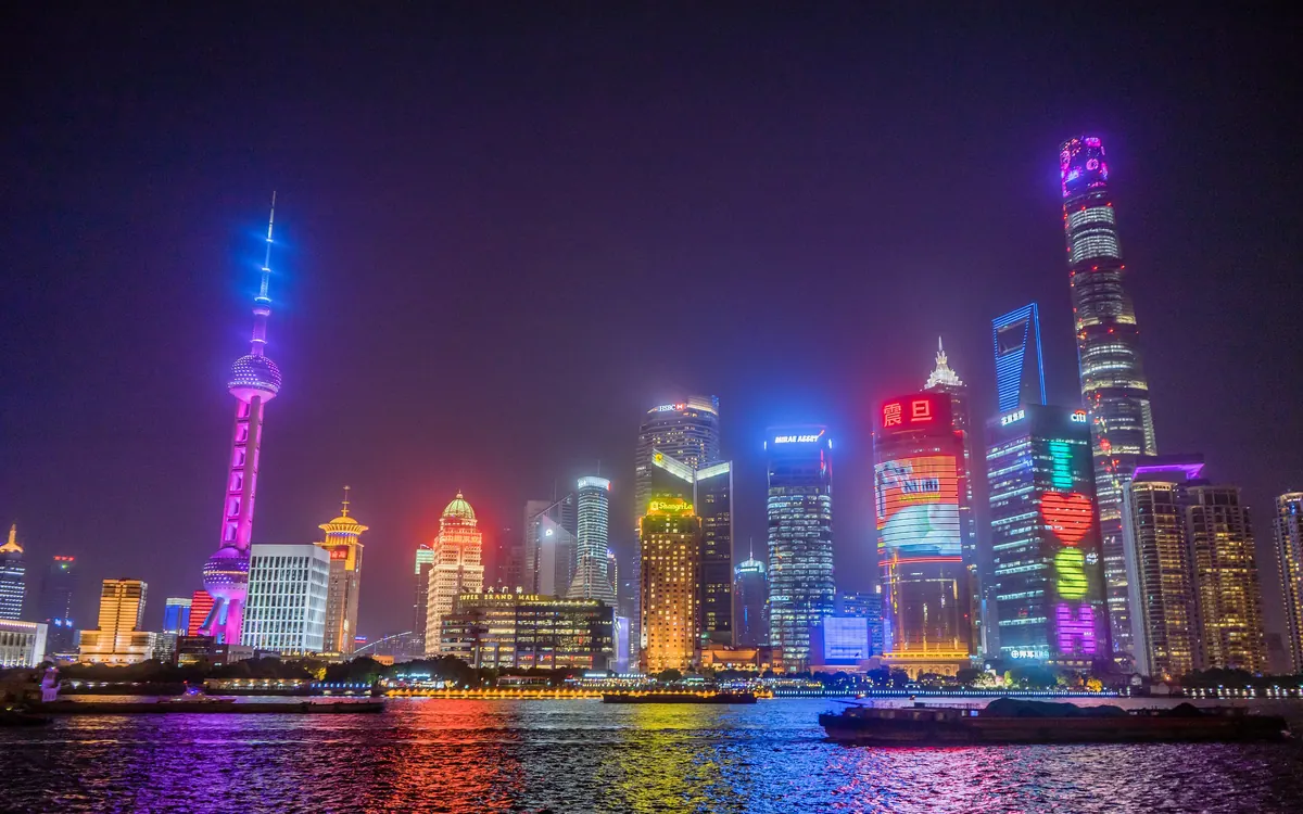Shanghai's Lujiazui skyline lit up at night across the Huangpu River (illustrative photo)