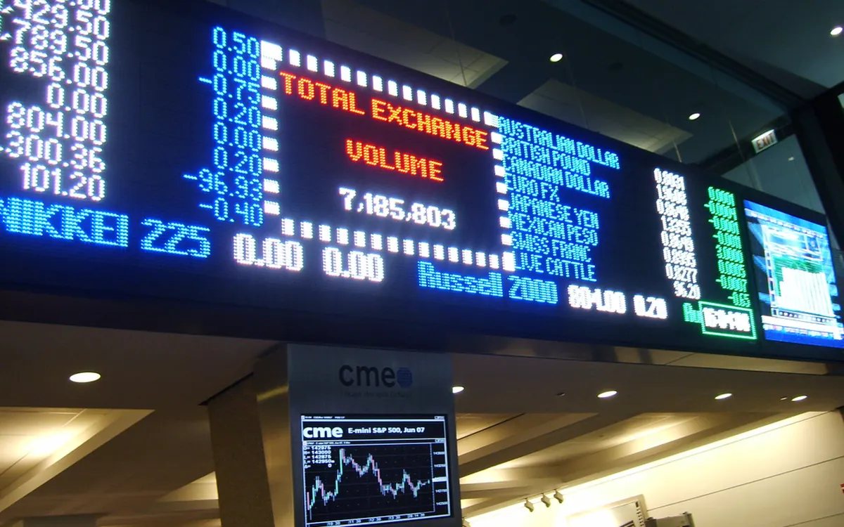 Electronic market board above the CME logo inside the Chicago Mercantile Exchange