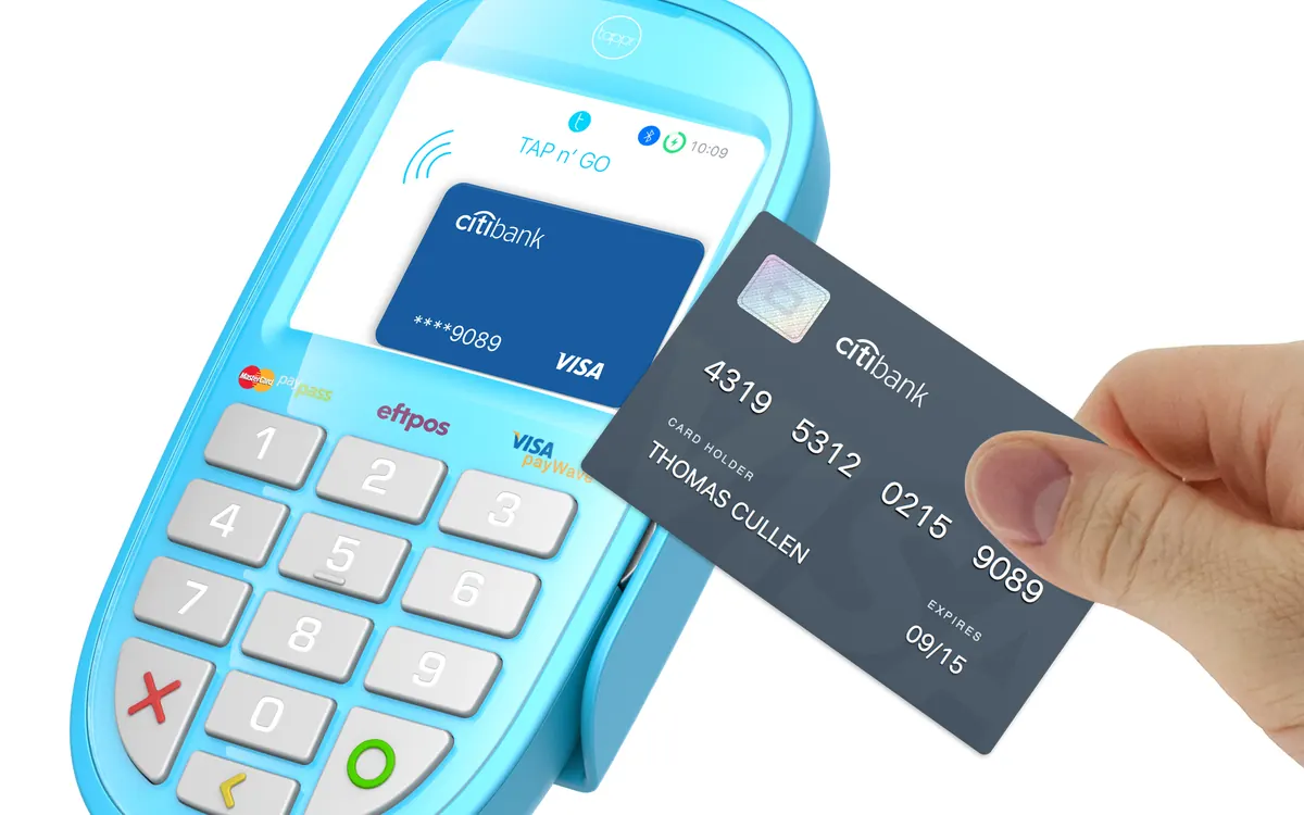 A contactless bank card being tapped on a handheld card reader (illustrative photo)