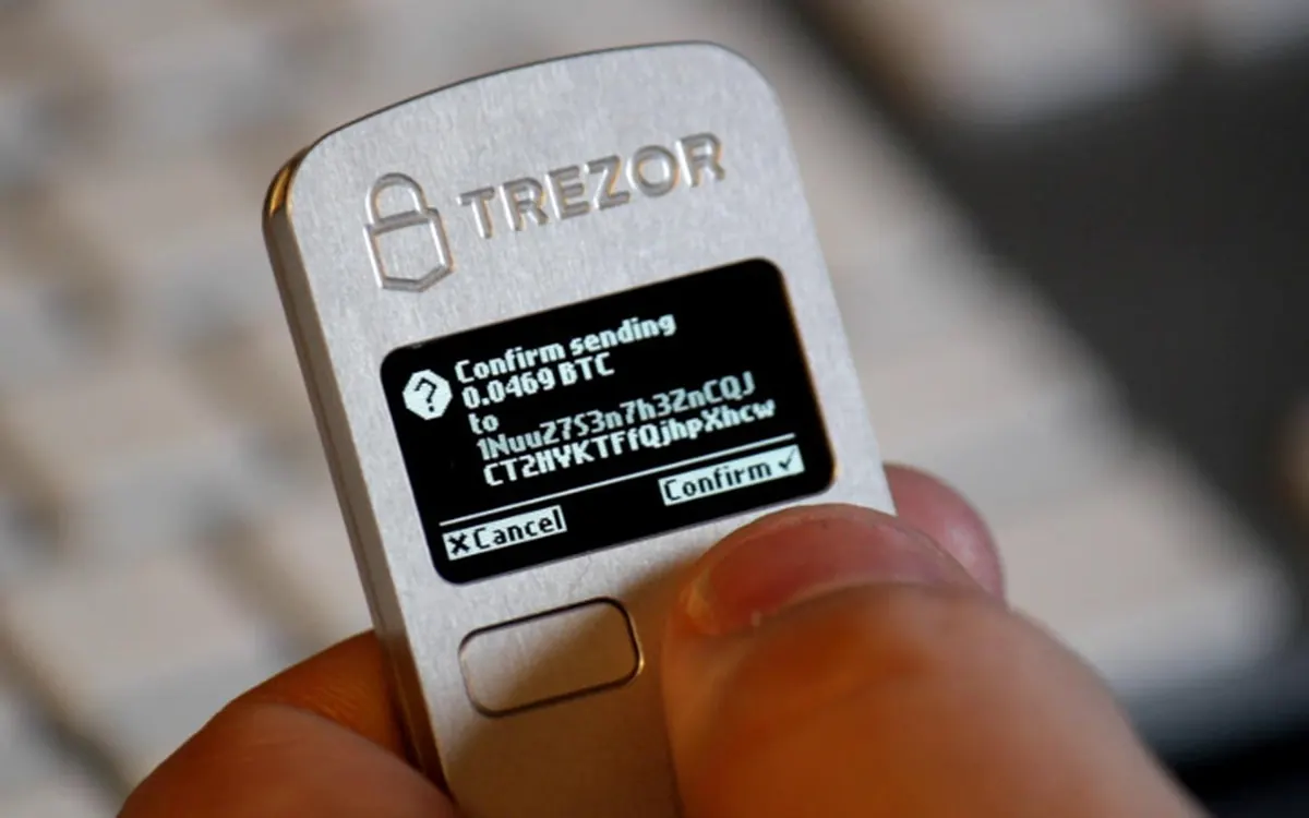 A Trezor hardware wallet screen asking the user to confirm a bitcoin payment and address (illustrative photo)