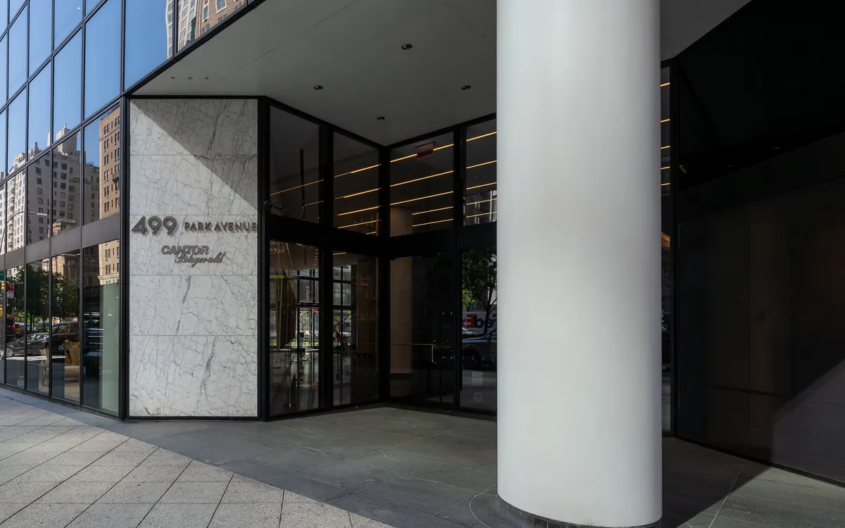 The entrance of 499 Park Avenue in New York with Cantor Fitzgerald's name on the stone wall (illustrative photo)