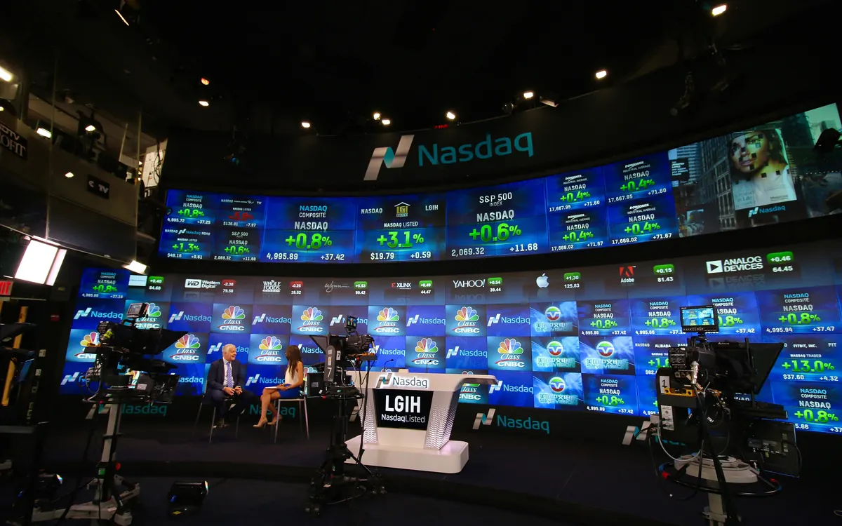 Inside the Nasdaq MarketSite studio in New York, with a curved wall of market screens