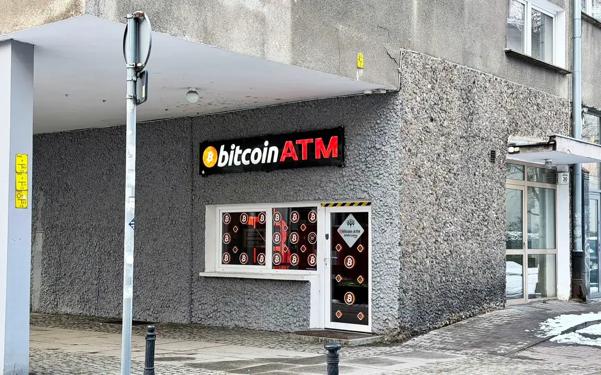 A bitcoin ATM sign on a building in Wrocław, Poland