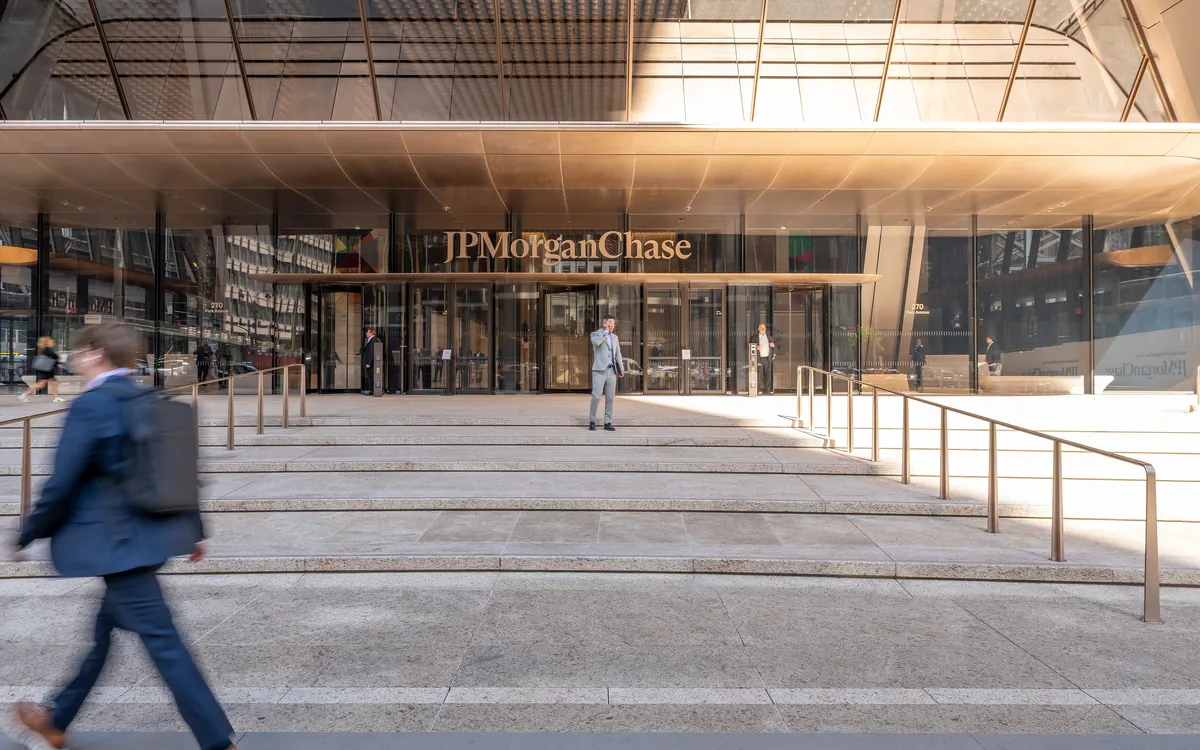 Entrance of JPMorgan Chase's 270 Park Avenue headquarters in New York with a man walking past