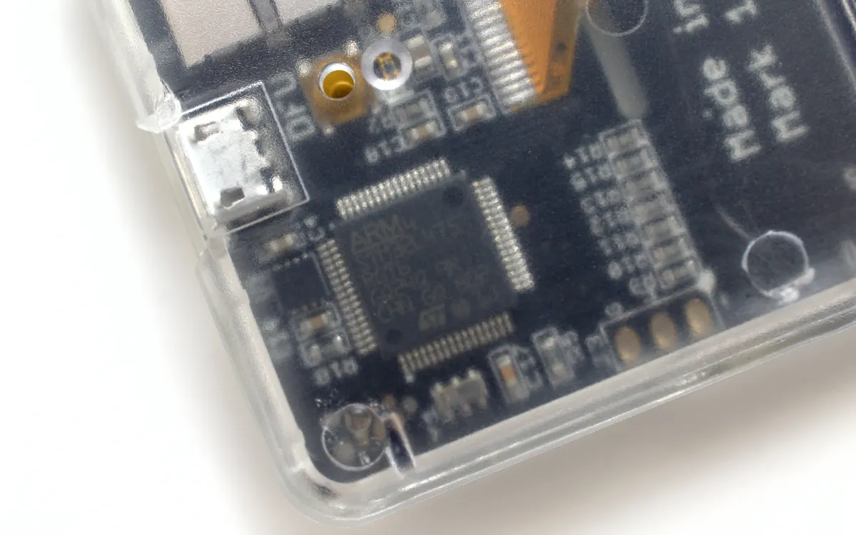 Close-up of the circuit board inside a transparent hardware wallet case (illustrative photo, not a Keystone device)