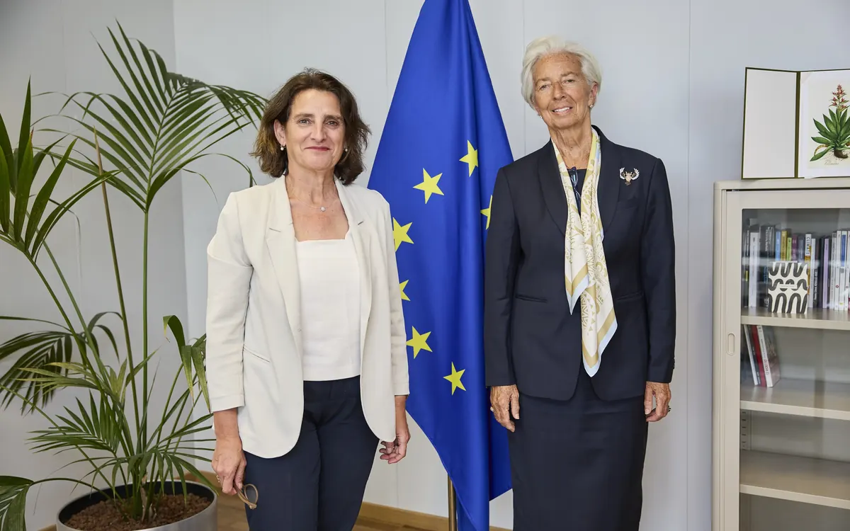 ECB President Christine Lagarde (right) with Teresa Ribera beside an EU flag at the European Commission