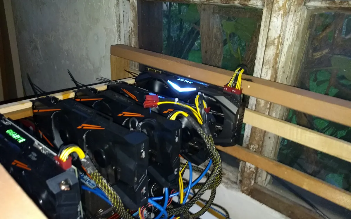 A GPU cryptocurrency mining rig with graphics cards on an open frame (illustrative photo)