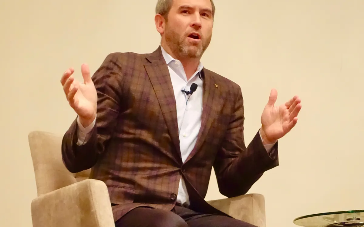 Ripple CEO Brad Garlinghouse speaking on stage (illustrative photo)
