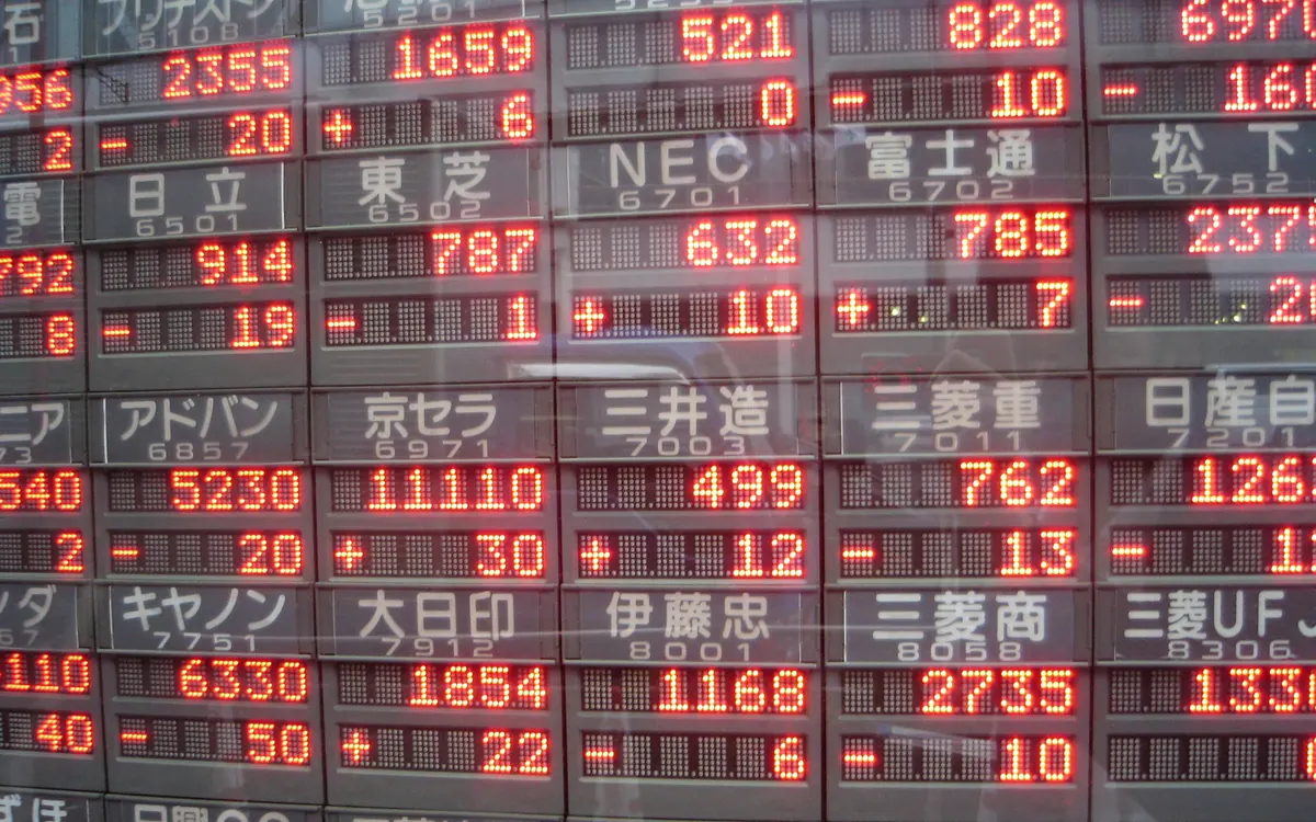 Electronic stock price board with share prices in red digits in Yaesu, Tokyo (illustrative photo)