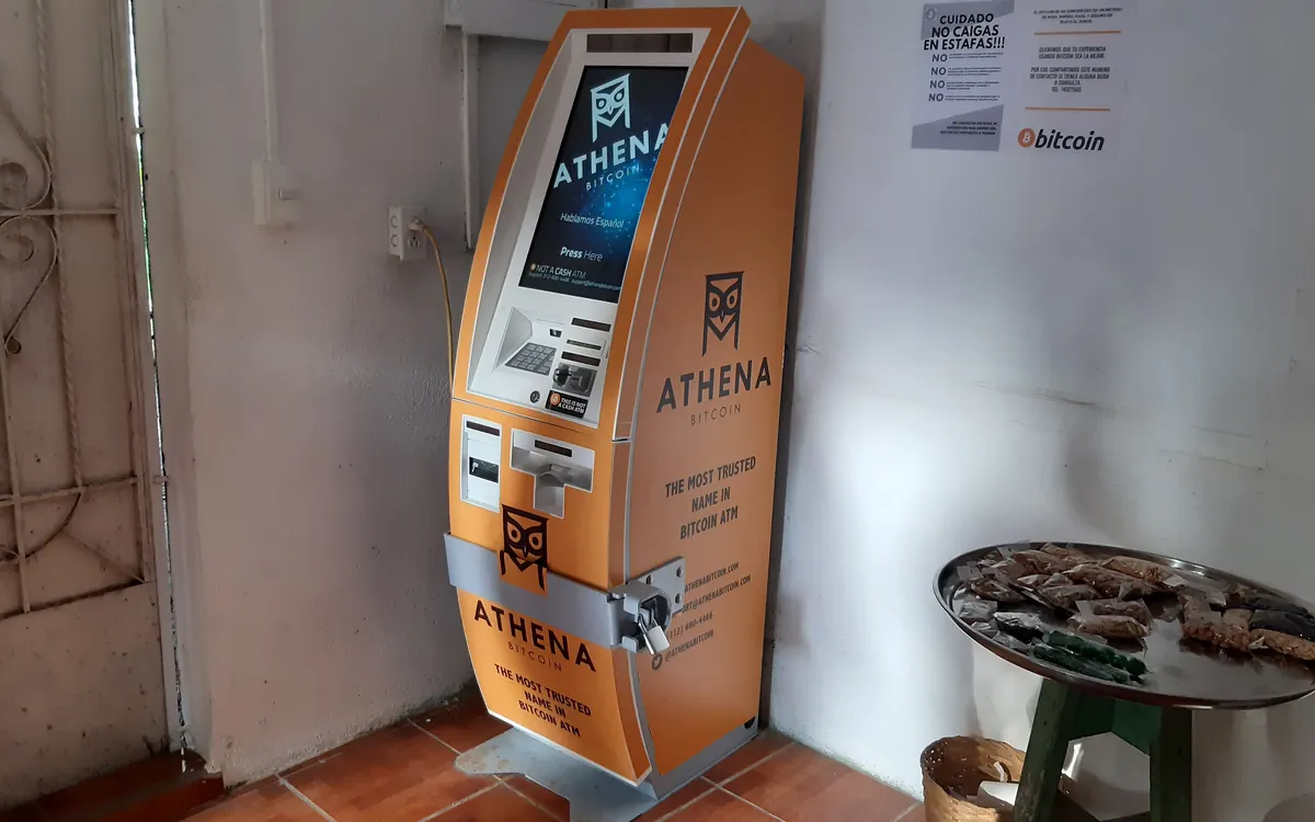 An orange Athena Bitcoin ATM indoors in El Zonte, El Salvador, the 'Bitcoin Beach' town known for Lightning payments (illustrative photo)